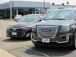 A toyota sedan and a Chevrolet SUV