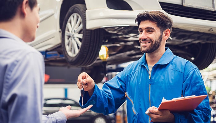 Mechanic handing keys to a customer
